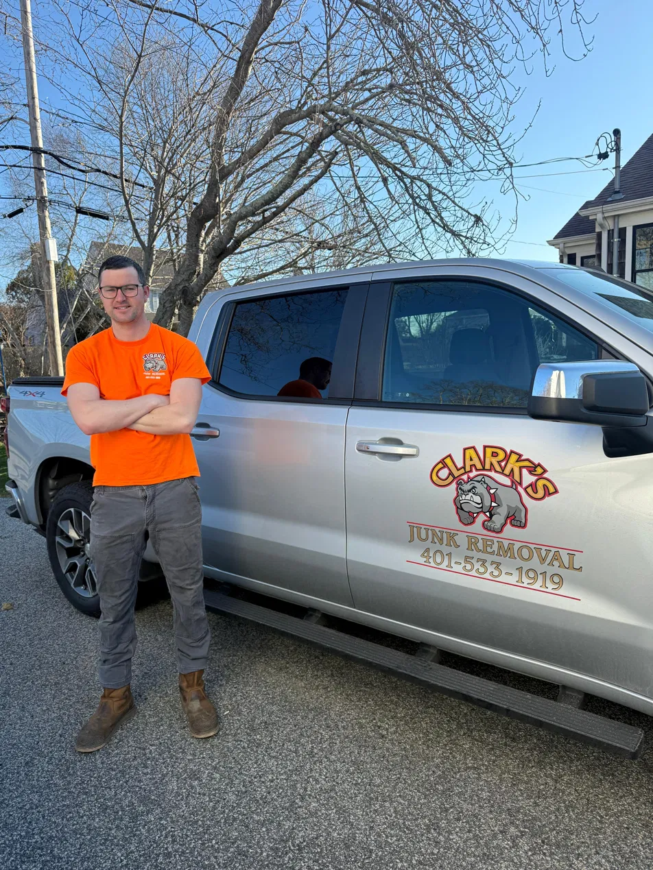 Coleman Clarke standing in front of Clark's Junk Removal truck